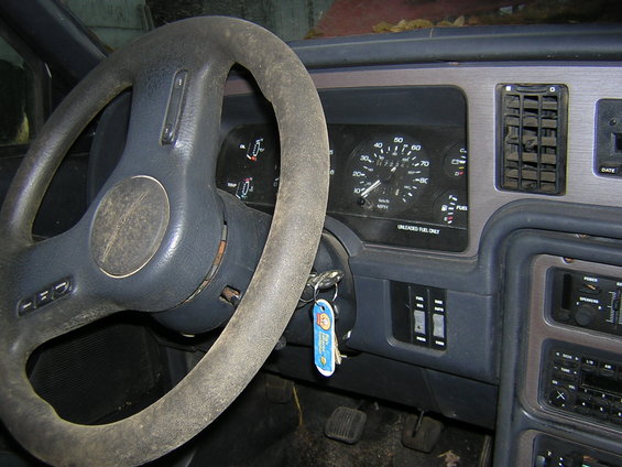 Interior view of a 1987 Ford Thunderbird showing the dashboard, steering wheel, and gauges