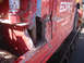 1979 Ford Bronco - Side view of a damaged red truck with the text EDRO and names visible on the panel.