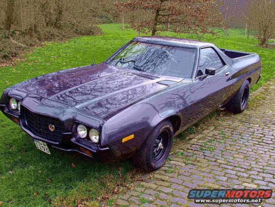 1972 Ford Ranchero parked on cobblestone driveway with grass and trees in background