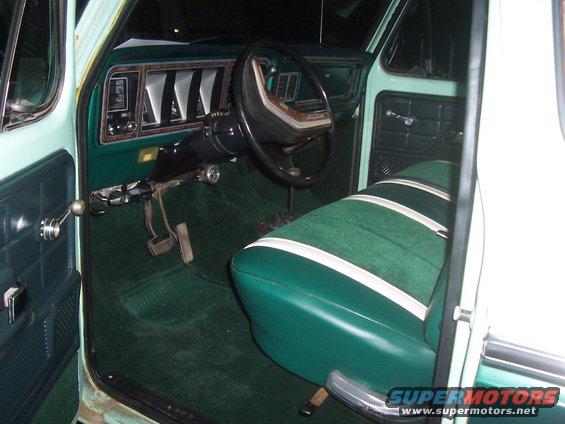Green and white striped bench seat and dashboard of a vintage truck