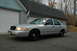 2003 Ford Crown Victoria - Silver 2003 Ford Crown Victoria police car parked in front of a garage.
