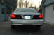 2003 Ford Crown Victoria - The rear of a silver Ford Crown Victoria is parked in a driveway next to a garage.