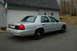 2003 Ford Crown Victoria - This silver 2003 Ford Crown Victoria is parked in front of a garage.