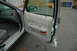 2003 Ford Crown Victoria - The interior door panel and dashboard of a 2003 Ford Crown Victoria are visible with the driver's door open.
