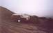 1989 Ford Bronco - A 1989 Ford Bronco navigates a steep, muddy incline under foggy conditions.
