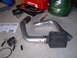 1996 Ford Probe - A cold air intake system is laid out on a concrete floor next to a toolbox and other tools.