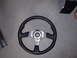 1996 Ford Probe - A black leather steering wheel with a silver center hub and MOMO branding is shown on a concrete floor.