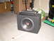 1996 Ford Probe - A car audio subwoofer with an amplifier stacked on top. The subwoofer has 'MTX' branding visible.