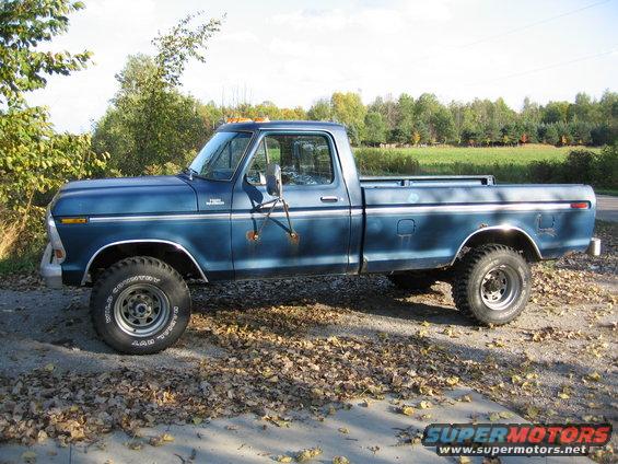 Side view of a blue 1978 Ford F-250 pickup truck with off-road tires