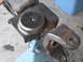 1991 Ford Bronco - A close-up view of a custom-welded metal part, likely for a vehicle suspension, resting on a blue jack.