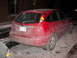 2002 Ford Focus - Rear view of a red 2002 Ford Focus hatchback parked outside in winter conditions.
