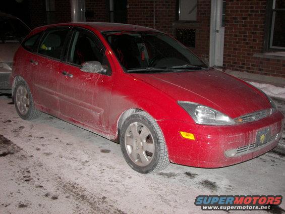 Red 2002 Ford Focus hatchback parked in snow