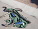 1996 Ford Probe - Several exhaust system components, including pipes and mufflers with chrome tips, are arranged on a green tarp.
