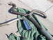 1996 Ford Probe - Several exhaust system components, including pipes and a muffler, are displayed on a green tarp outdoors.