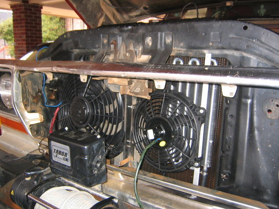 Front of vehicle showing radiator, dual electric fans, and a Tabor winch