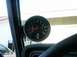 1978 Ford Bronco - A close-up view of a tachometer mounted inside a vehicle, showing the engine's revolutions per minute.