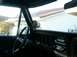 1978 Ford Bronco - Interior view of a 1978 Ford Bronco, a custom gauge and original dashboard components.