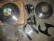1992 Ford Mustang - Car brake parts including rotors, calipers, and brackets are displayed on the floor.