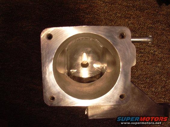 Aluminum throttle body interior with a circular opening and mounting holes