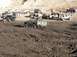 1978 Ford Bronco - A heavily modified 1978 Ford Bronco navigates a challenging off-road course filled with mud and other vehicles.