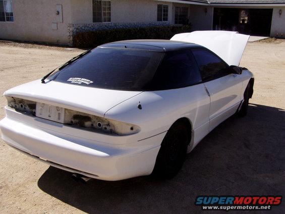 White 1993 Ford Probe with black roof, hood open, rear quarter view