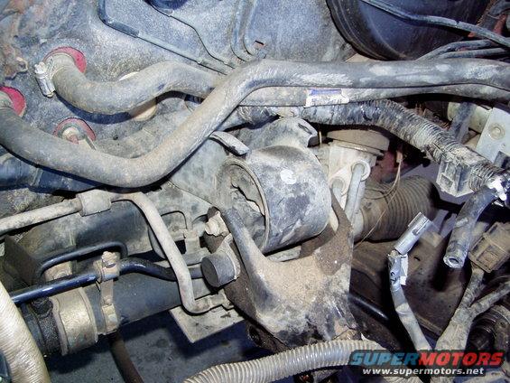 Engine mount with hoses and wiring visible