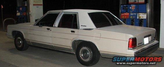 1991 Ford Crown Victoria LTD parked at a gas station at night