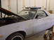 1973 Ford Ranchero - This 1973 Ford Ranchero is shown in a light gray primer with its hood open, revealing the engine bay.