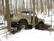 1979 Ford Bronco - This 1979 Ford Bronco is stuck in the mud and snow, surrounded by trees in a wooded area.