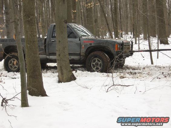 Gray Dodge Dakota stuck in snow, 3q-front view
