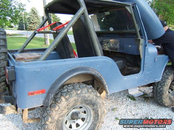 Blue 1980 Jeep CJ5 with roll cage, open hood, and off-road tires