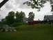1994 Ford Bronco - A black Ford Bronco is parked on a grassy area next to a red pickup truck.