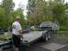 1994 Ford Bronco - A truck is being loaded onto a trailer by several people.