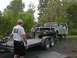 1994 Ford Bronco - A 1979 Ford F-Series truck is winched onto a trailer by two men.