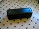 1986 Ford Bronco - This black rectangular object, possibly a tool case or storage box, sits on a tiled floor. It has a latch on the front and two blue lines o…