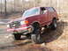 1991 Ford Bronco - This lifted 1991 Ford Bronco navigates a challenging off-road terrain with large tires and a high suspension.