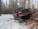 1991 Ford Bronco - A red 1991 Ford Bronco navigates a snowy incline in a forest setting.