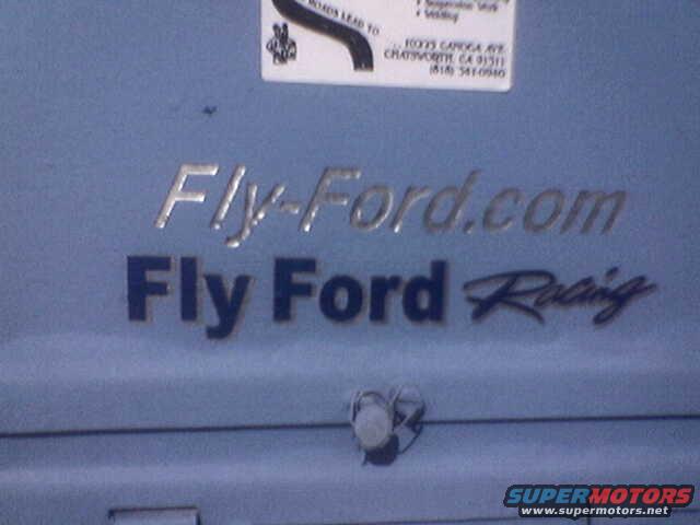 Blue metal surface with "Fly-Ford.com" and "Fly Ford Racing" text