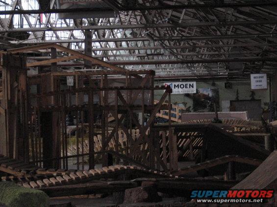 Wooden ramps and structures inside a warehouse with "MOEN" signage visible