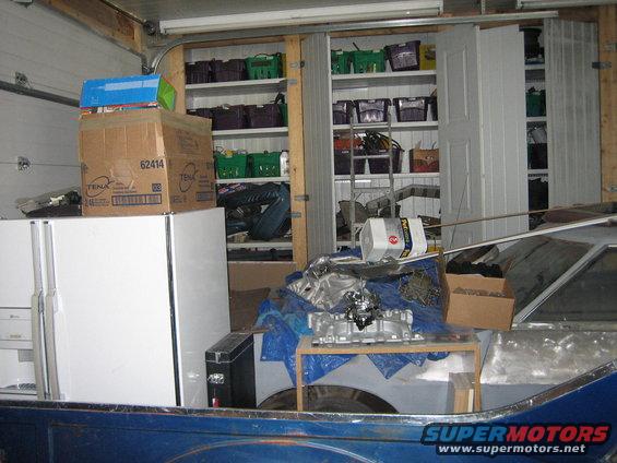 Blue pickup truck bed with carburetor on table