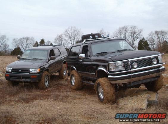 1995 Ford Bronco and a Toyota 4Runner on a muddy trail