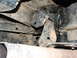 1996 Ford Bronco - Undercarriage view of a vehicle's suspension or exhaust mounting bracket.