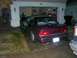 1991 Ford Bronco - Maroon sedan with dual exhaust pipes parked in a driveway, with a garage in the background.