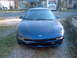 1994 Ford Probe - A blue Ford Probe is parked in front of a residential house.