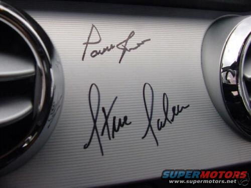 Dashboard trim with two signatures, one above the other. Chrome air vents on left and right