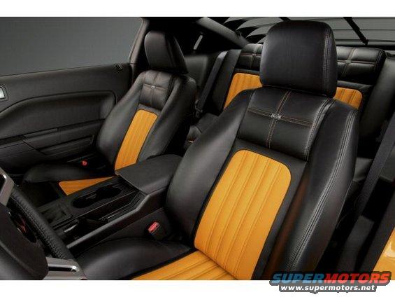 Interior view of black and orange seats with stitching detail