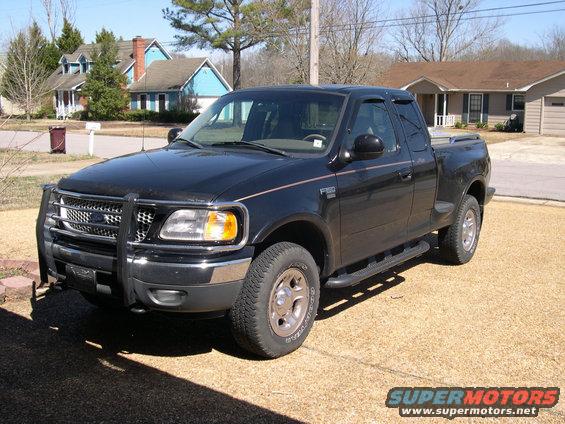 Black Ford F-150 pickup truck parked in a driveway