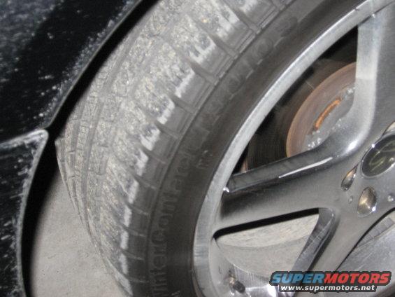 Close-up of a car tire with 'WinterContact' text and a chrome alloy wheel