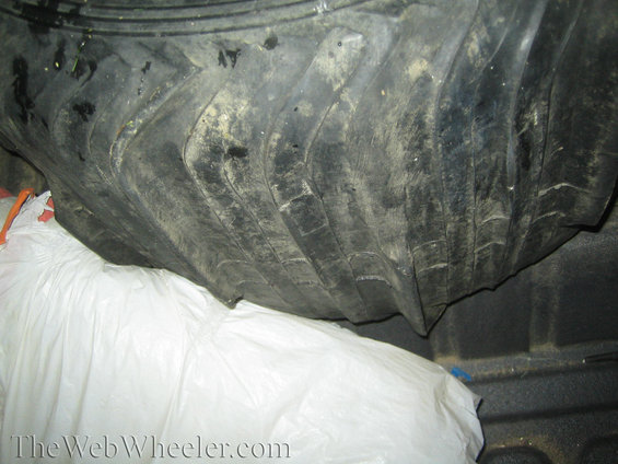 Paddle tires loaded in truck bed next to white bags