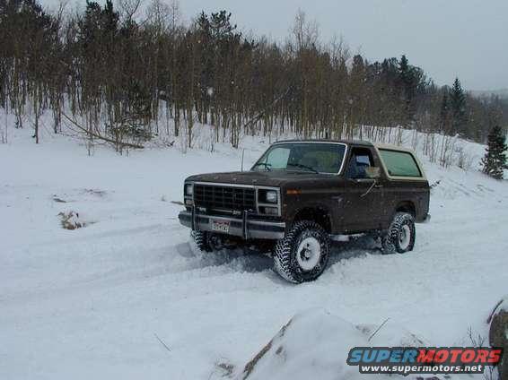 Brown 1980 Ford Bronco in snow, 3q-front view